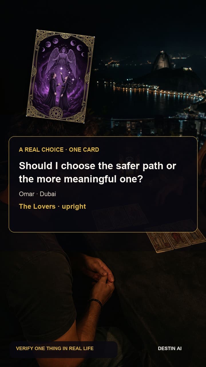 Should I choose the safer path or the more meaningful one? — seated face-to-face with the tarot reader, comparing two mirrored three-card spreads before making a note in Dubai tarot terrace after dark with distant skyline lights, with The Lovers upright